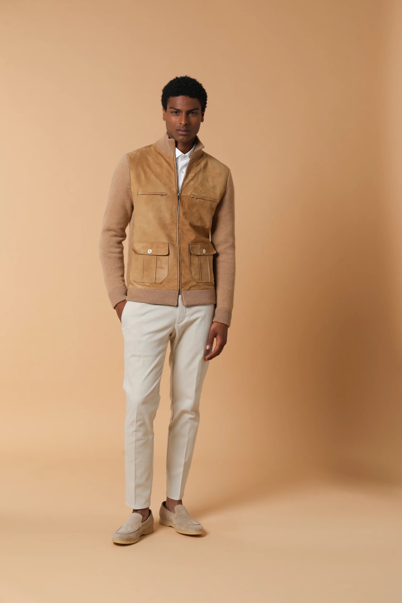 Bomber elegante e sofisticata, realizzata in cashmere con applicazione di suede sul davanti. Contiene 6 tasche ed un doppio cursore. Colore Cammello